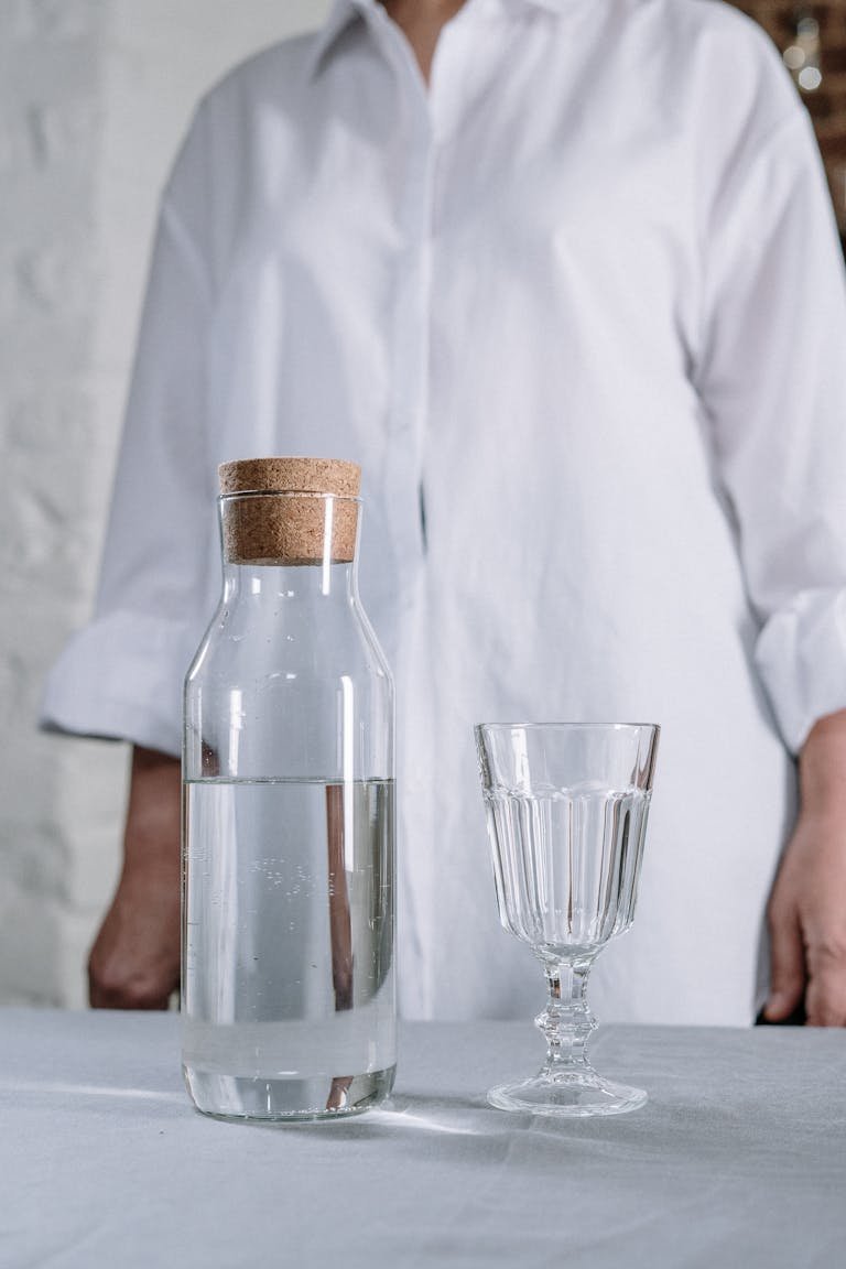 Minimalist still life of a water carafe and glass, perfect for home decor themes.